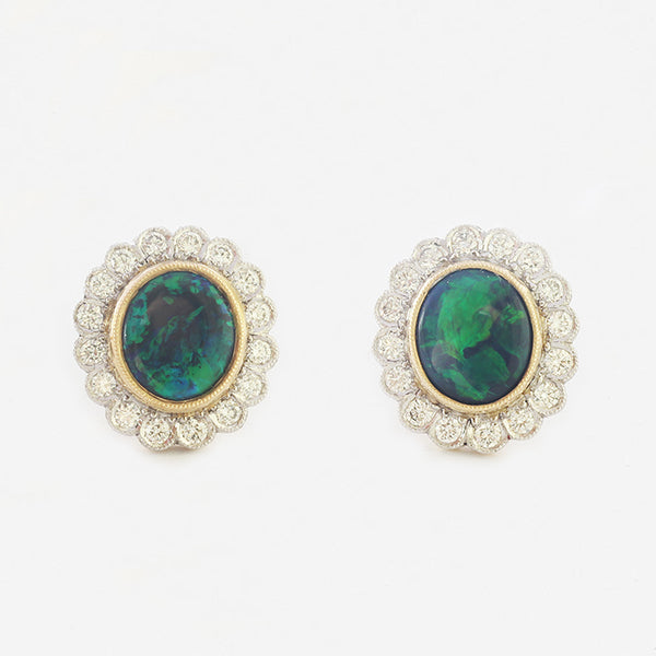 a pair of beautiful black opal and diamond oval cluster studs in 18 carat gold