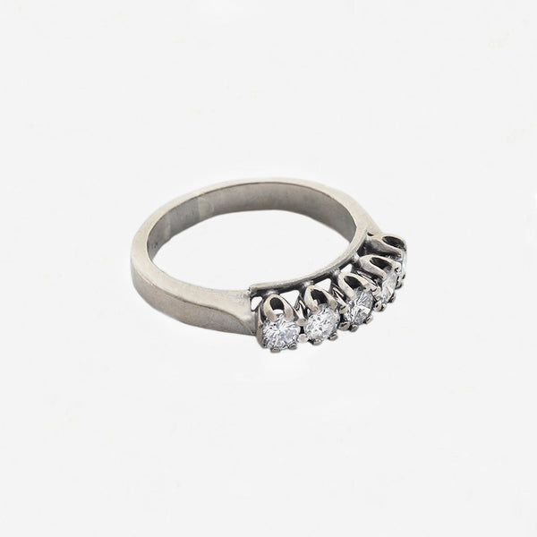 white gold claw set round diamond ring sitting sideways with white background
