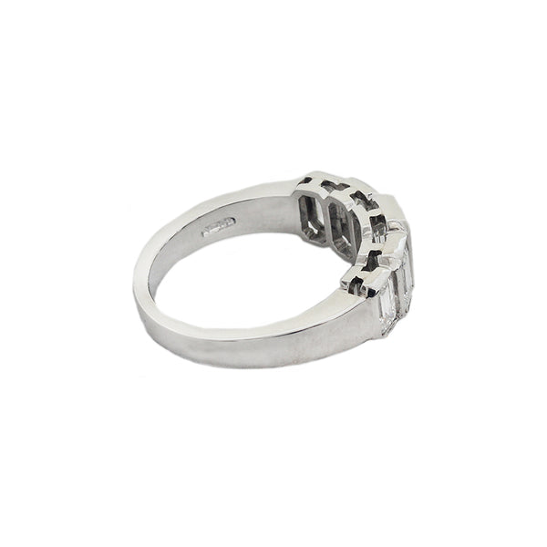 Side view of a five stone graduated diamond ring in platinum. Emerald cut Diamonds are rub over set in individual settings