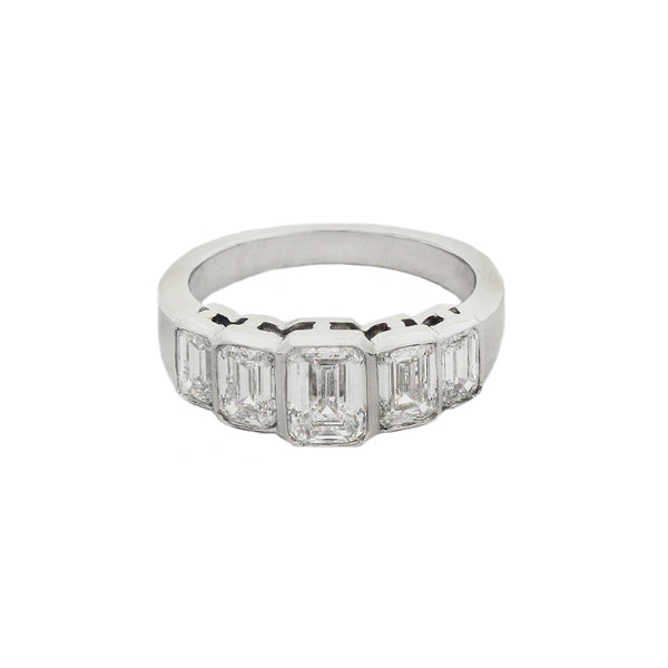 Front view of a five stone graduated diamond ring in platinum. Emerald cut Diamonds are rub over set in individual settings