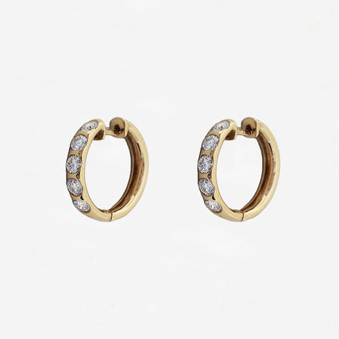 Gold hoop earrings with embedded diamonds on a white background