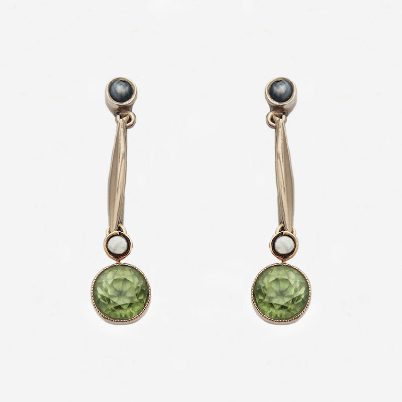 Pair of earrings with green gemstones on a white background