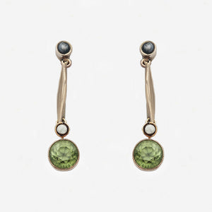 Pair of earrings with green gemstones on a white background