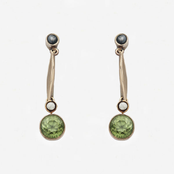 Pair of earrings with green gemstones on a white background