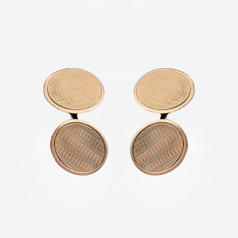 Pair of gold round cufflinks on a white background