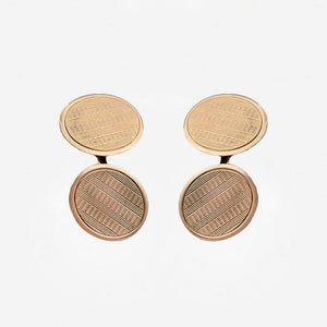Pair of gold round cufflinks on a white background