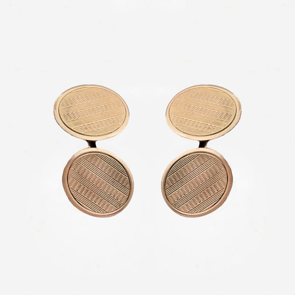 Pair of gold round cufflinks on a white background