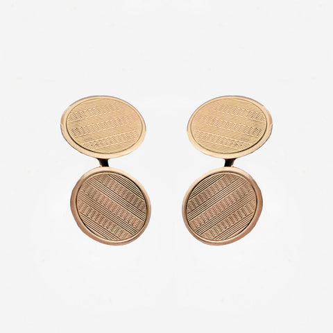Pair of gold round cufflinks on a white background