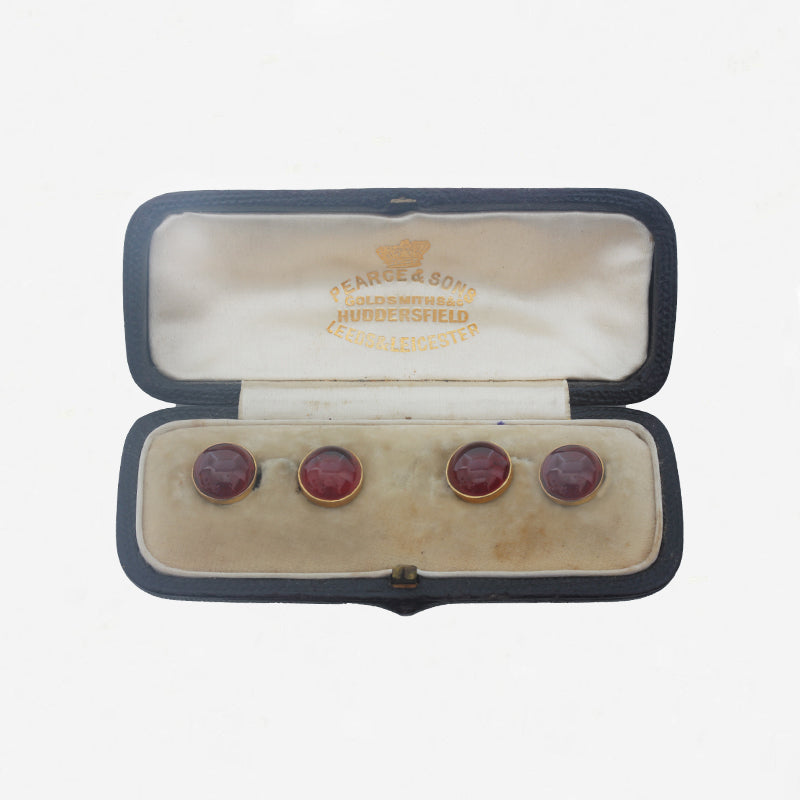 round garnet dress studs in a box