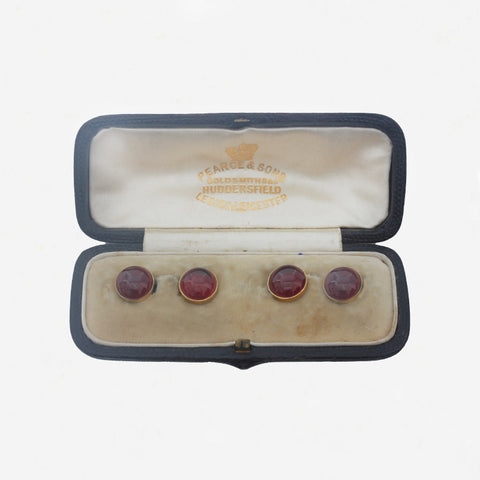 round garnet dress studs in a box