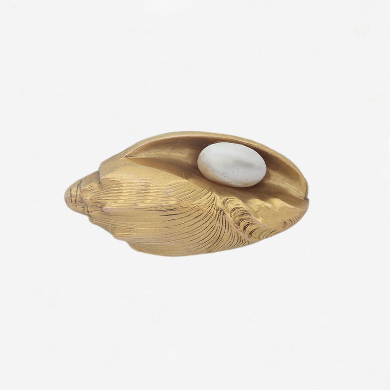a yellow gold shell brooch with oval pearl