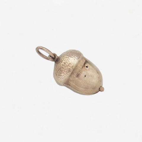 a vintage gold hollow acorn charm