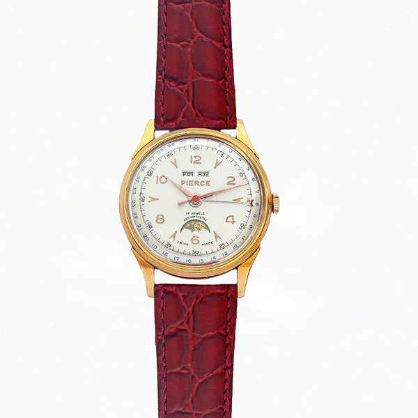 Watch with red strap and gold casing on a white background
