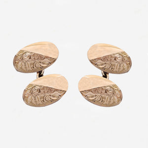 Set of gold cufflinks with intricate designs on a white background rose