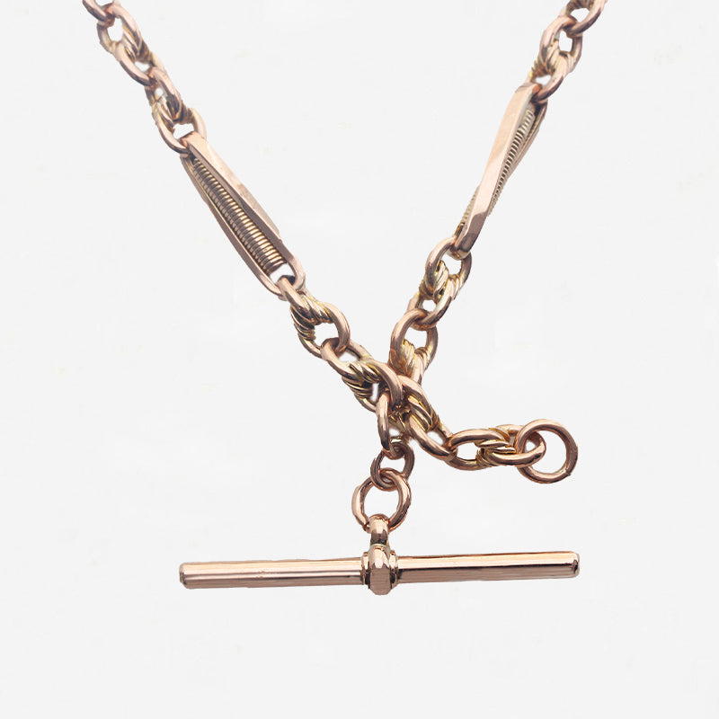 Rose gold necklace with a clasp on a light grey background