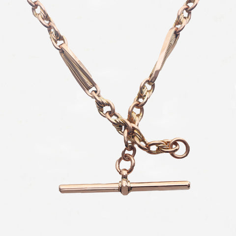 Rose gold necklace with a clasp on a light grey background