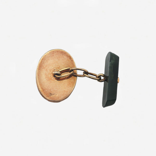 single jade cufflink with yellow gold back 