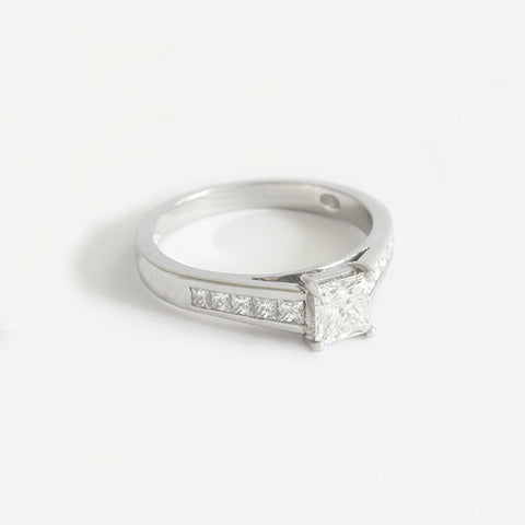 a platinum diamond ring with square shape centre and diamond shoulders