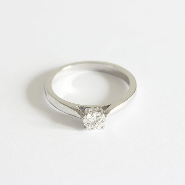 a diamond engagement ring with 4 claw setting 