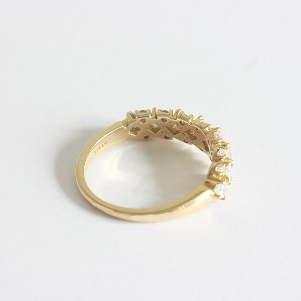 a yellow gold diamond set half hoop ring with claw settings