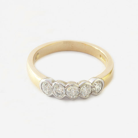 a five stone diamond two tone half eternity ring in a rubber set