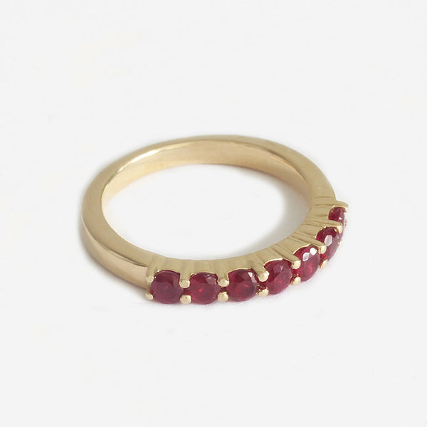 a yellow gold 7 stone claw set round ruby ring 
