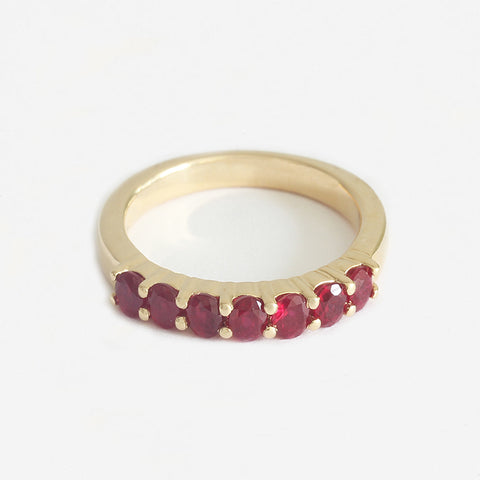 a seven stone yellow gold claw set half eternity ring in yellow gold