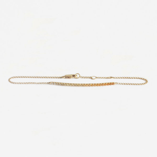 a yellow gold bracelet with yellow and orange sapphires