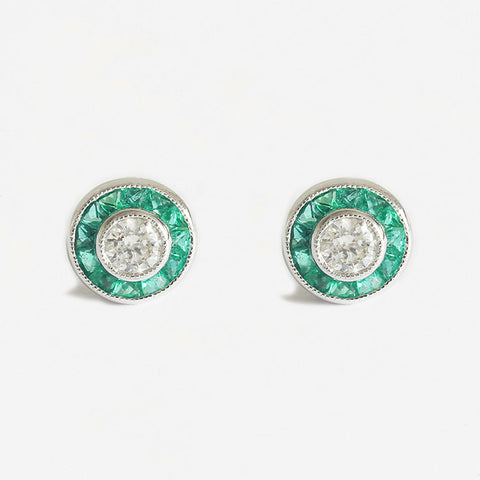 a stunning pair of emerald and diamond round cluster stud earrings in white gold