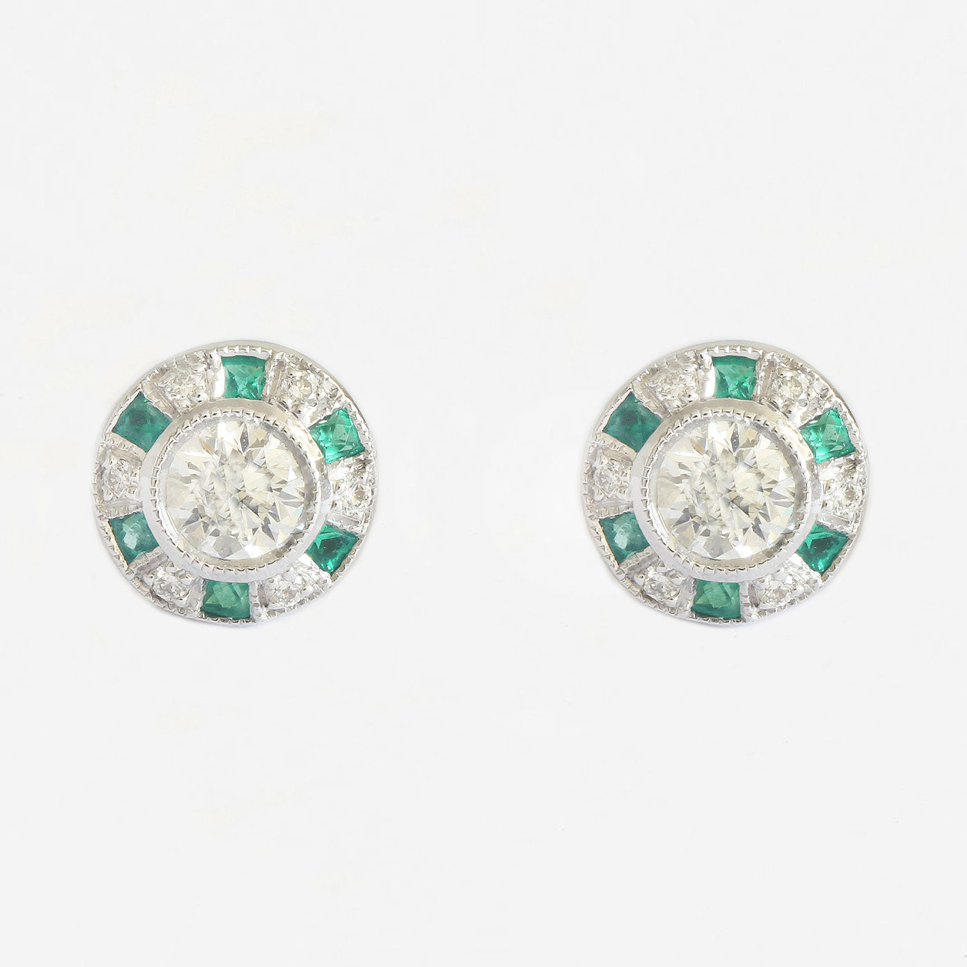 a pair of emerald and diamond round cluster studs