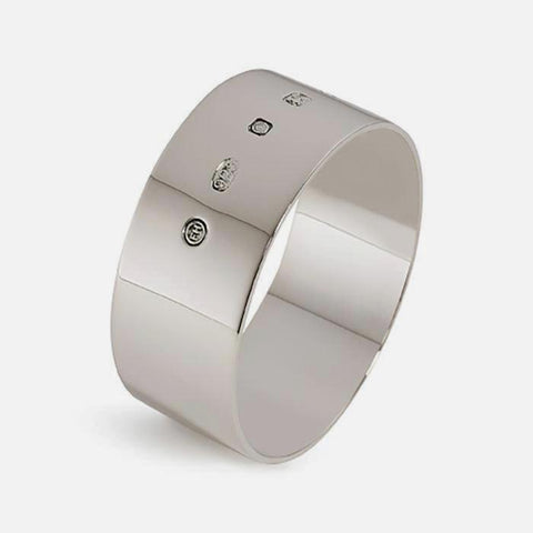 a plain polished napkin ring in sterling silver with a full hallmark on the outside and oval in shape