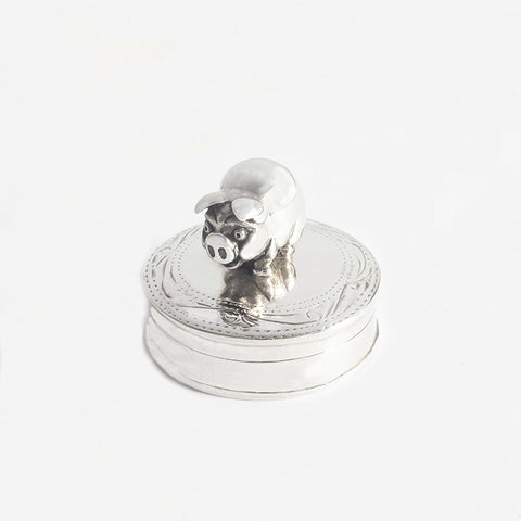 a silver modern pig design patterned circular pill box