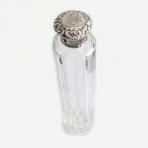 a silver and glass hatpin bottle with hmb initials on top hallmarked 1896