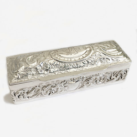 a victorian silver rectangular embossed box with initials and scroll floral design 1897