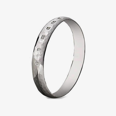 a gents sterling silver bangle with a hammered pattern and large hallmark