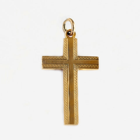 a yellow gold cross with a double groove wavy edge