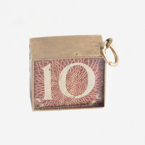 a 10 shilling note wrapped inside a gold cased box as a charm 