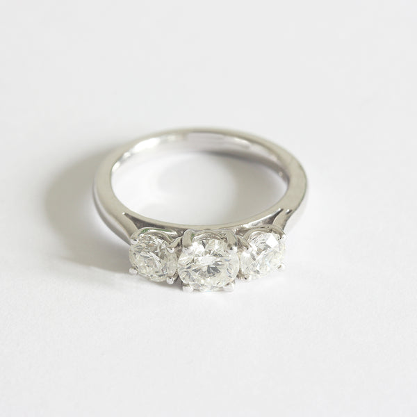 Front view of a three stone Diamond ring in white gold. The graduated round diamonds are four claw set