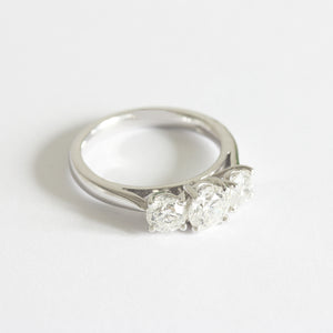 A three stone Diamond ring in white gold. The graduated round diamonds are four claw set