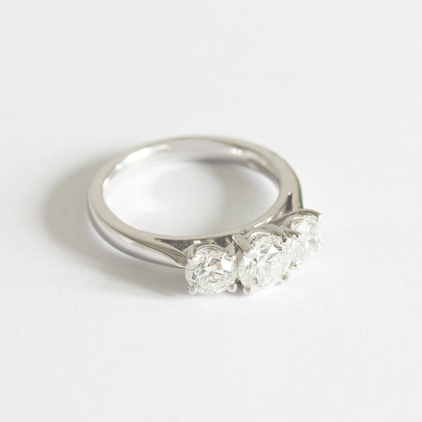 A three stone Diamond ring in white gold. The graduated round diamonds are four claw set