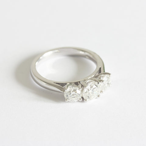 A three stone Diamond ring in white gold. The graduated round diamonds are four claw set