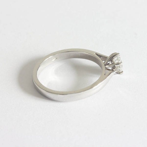 Side view of a solitaire modern brilliant cut diamond ring in platinum. The diamond is six claw set 