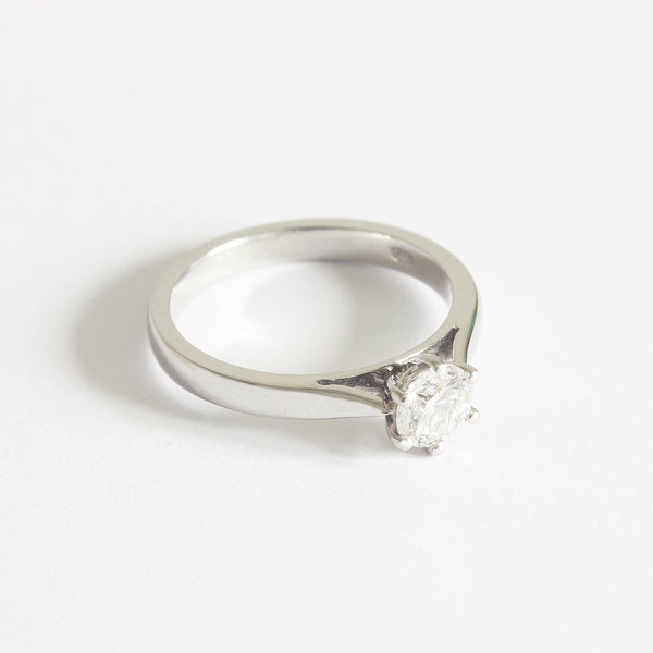 A solitaire modern brilliant cut diamond ring in platinum. The diamond is six claw set 