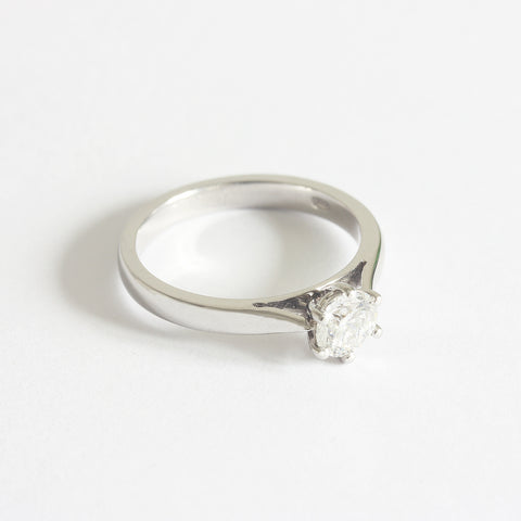 A solitaire modern brilliant cut diamond ring in platinum. The diamond is six claw set 
