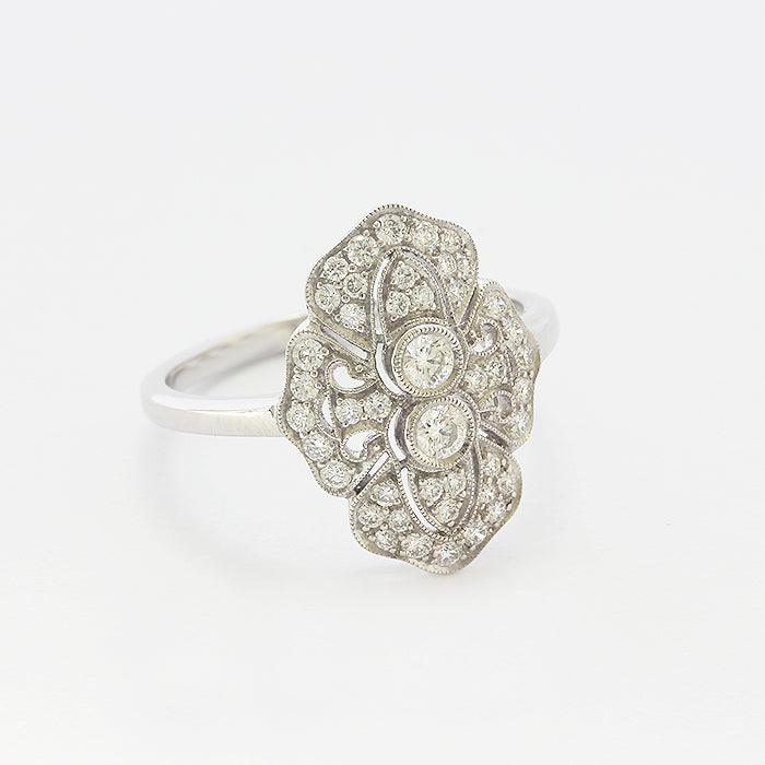 A Diamond cluster Art deco style ring in 18ct white gold with a grain setting edge