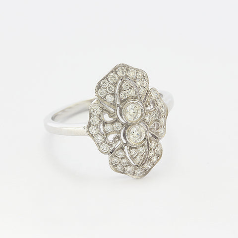 A Diamond cluster Art deco style ring in 18ct white gold with a grain setting edge