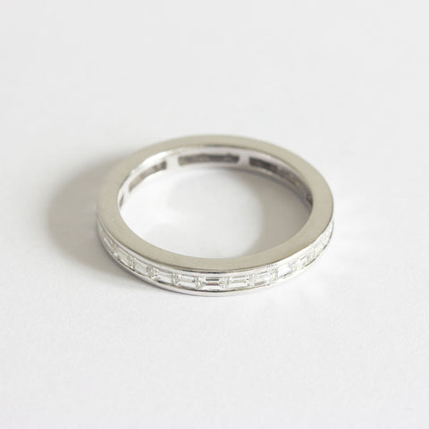 A twenty eight stone diamond channel set eternity ring in white gold. The stones are baguette cut