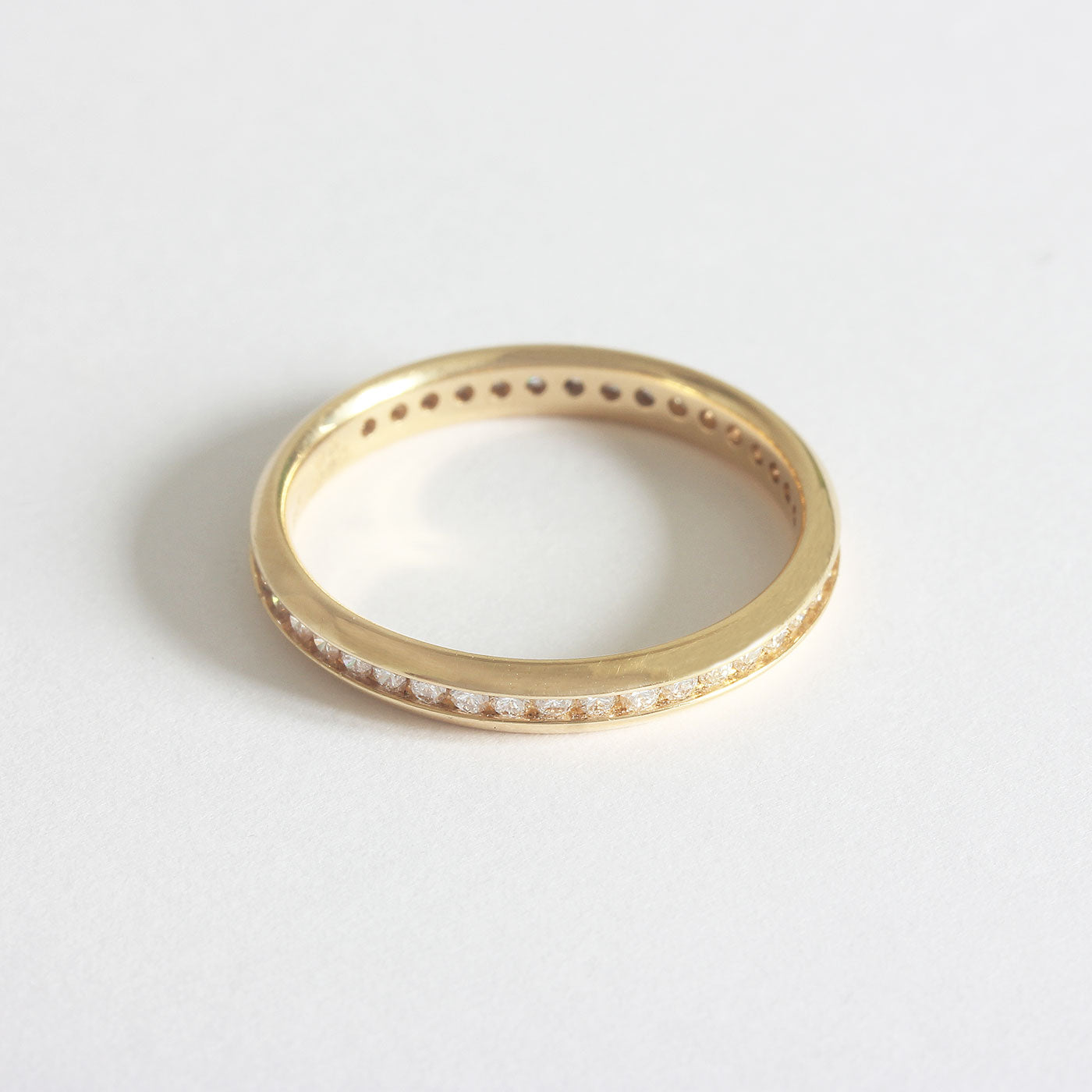 A forty two stone diamond full eternity ring in 18ct yellow gold. The stones are modern briiliant cut in a channel setting