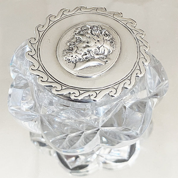 a victorian ink stand in silver and cut glass with head design and scroll edge