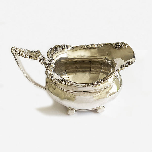 a silver ornate floral milk jug hallmarked in chester